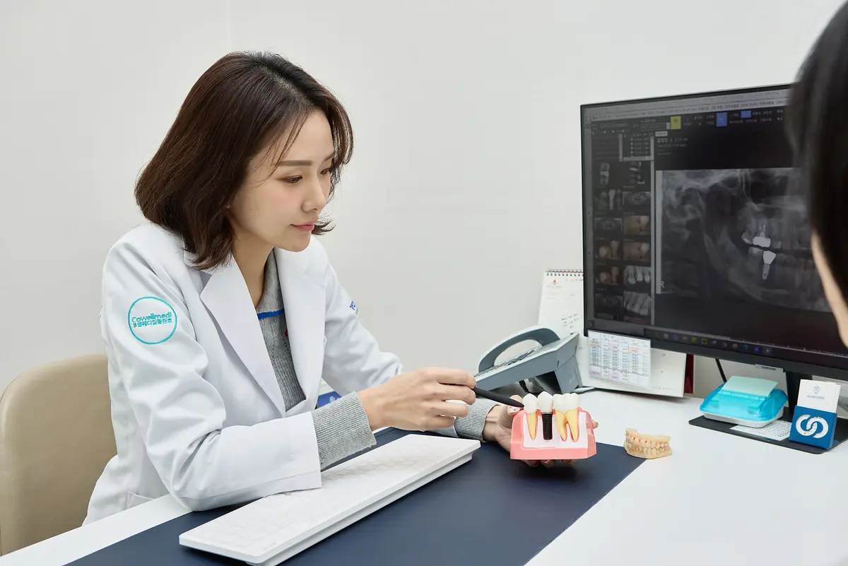 Dentist reviewing an X-ray on screen